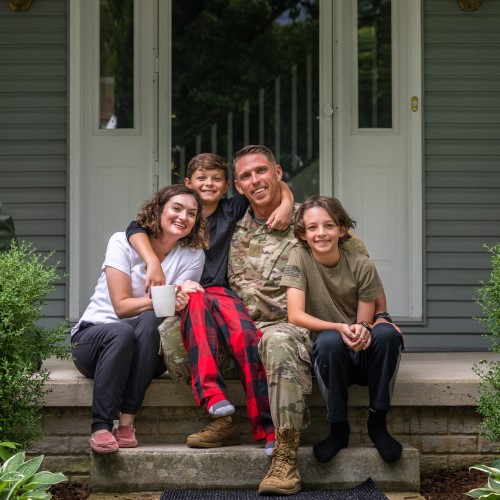 Air Force service member poses with family for group photo